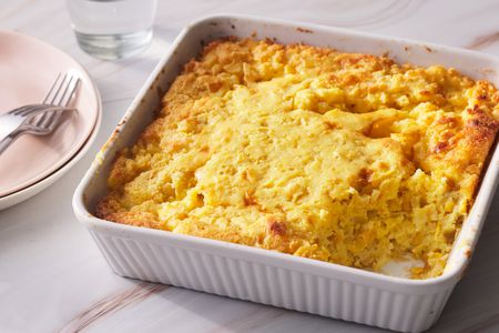 Cornbread pudding served in a white casserole dish. 