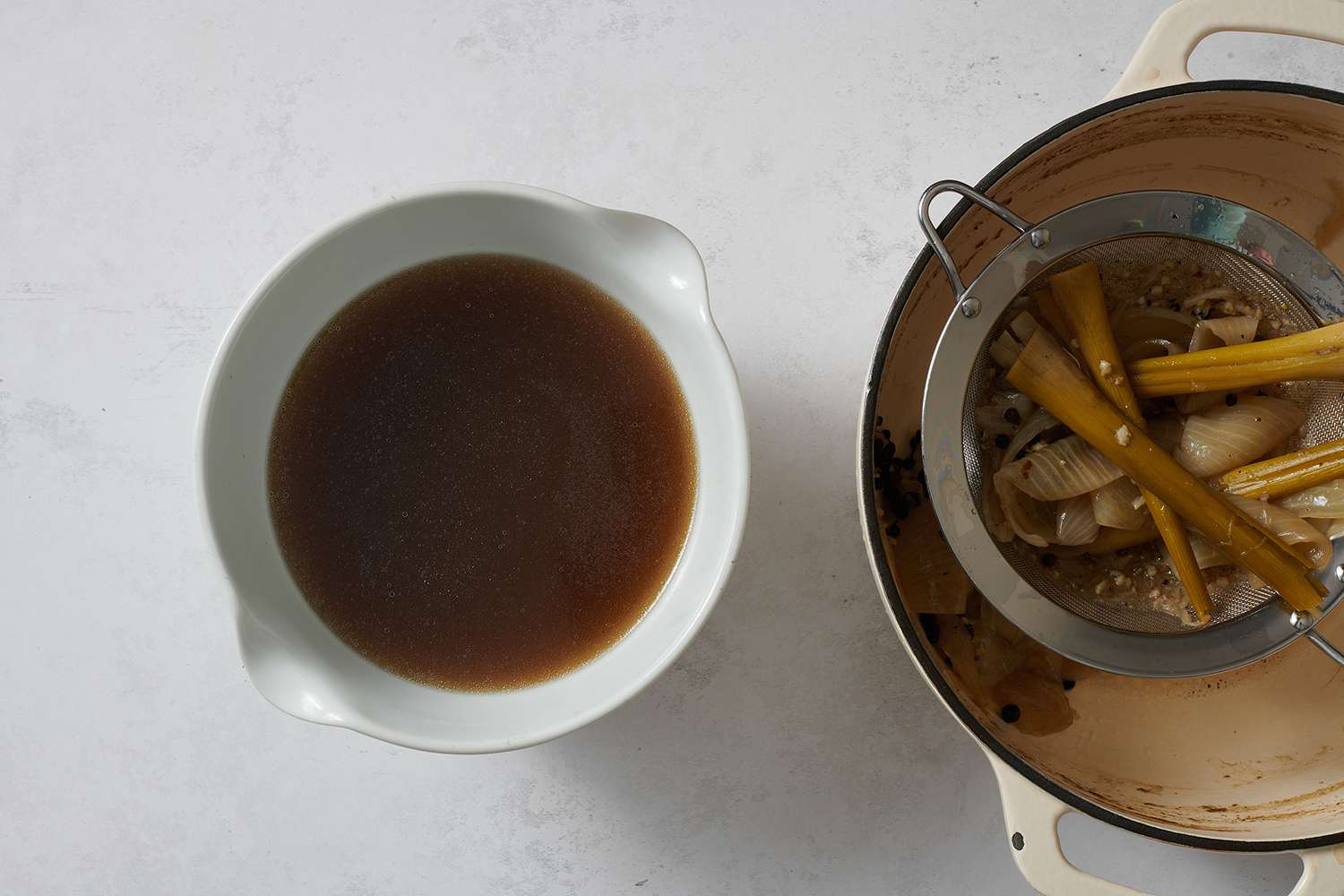 Strained braising liquid in a bowl