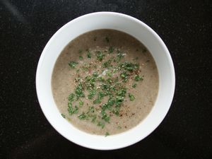 Potato Mushroom Soup in white bowl on black background