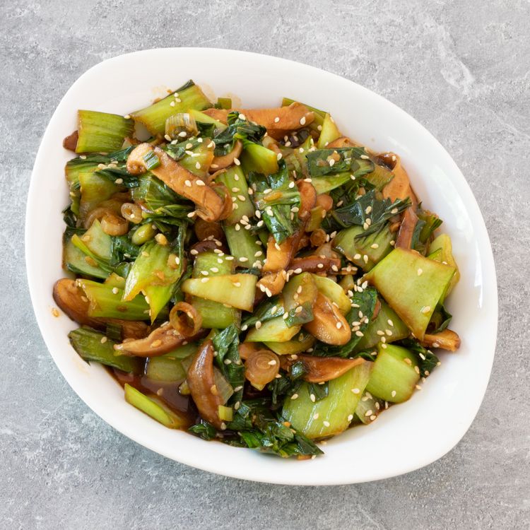 Bok choy shiitake mushroom stir fry in a white bowl