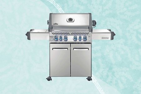 Napoleon Prestige 500 Propane Gas Grill on a blue background