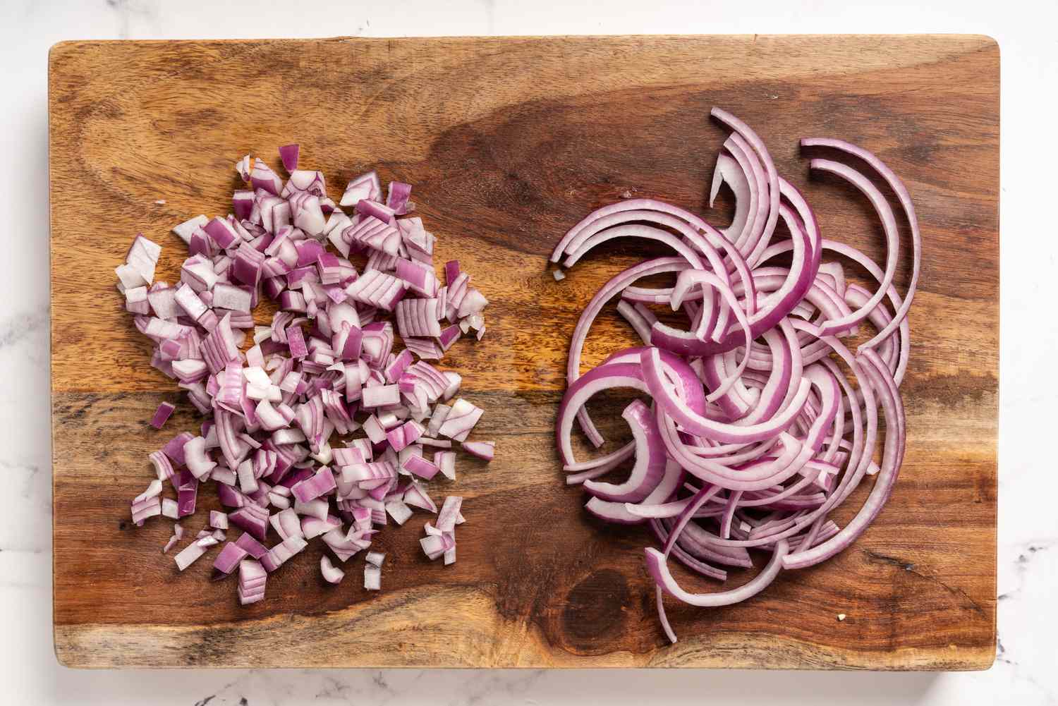 Chopped and sliced red onions on a cutting board 