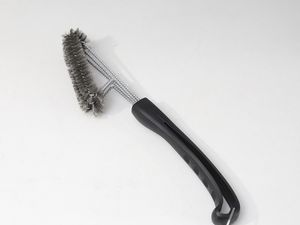 Kona 360° Clean Grill Brush displayed on marble countertop with nearby tile backsplash