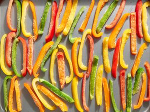 A baking sheet of frozen strips of bell peppers