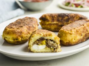 A plate holding four Papa rellenas