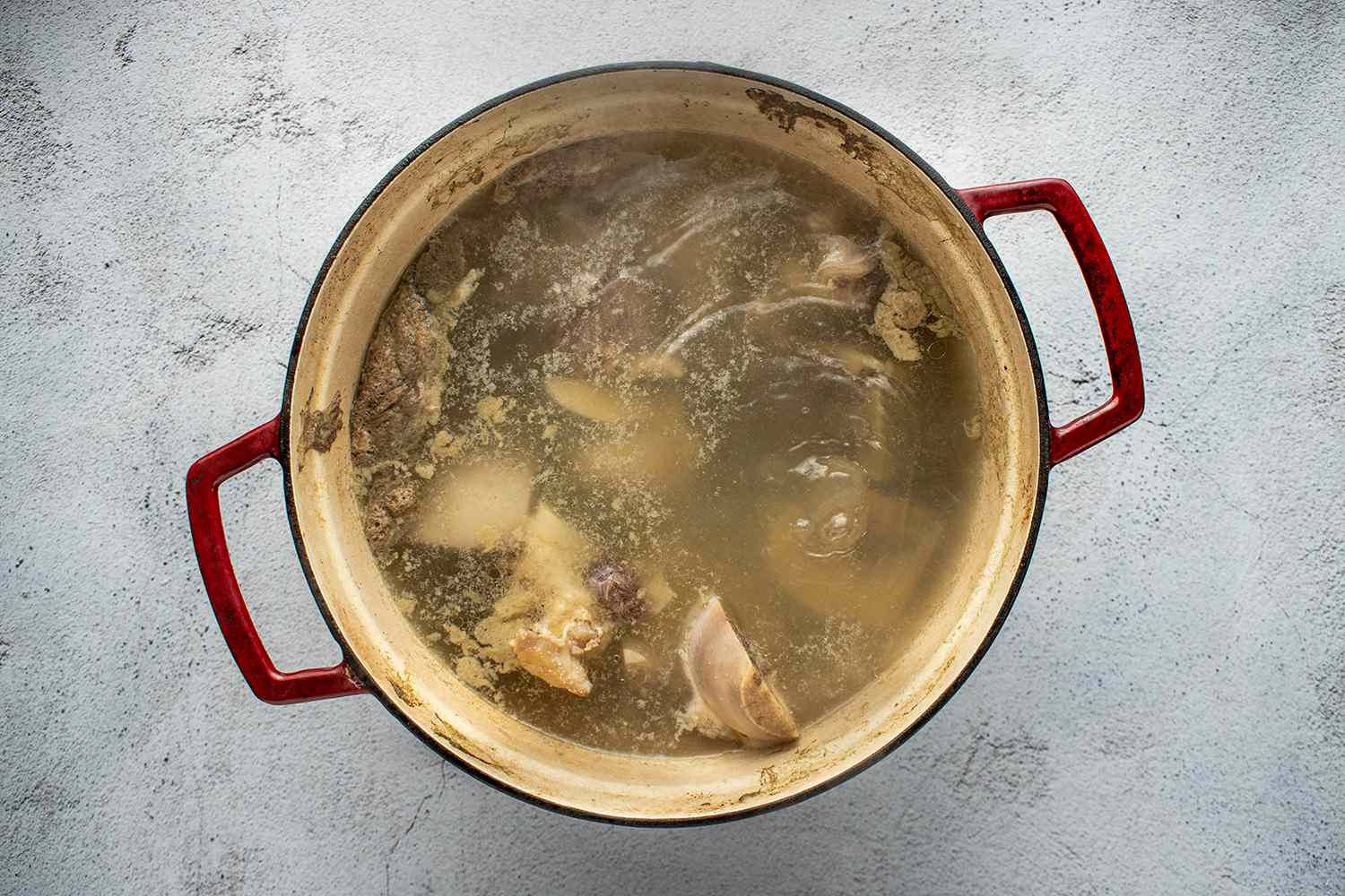 Beef soup bones in a pot with water 