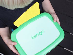 Hands holding the Bentgo Kids Lunch Box