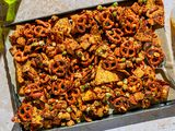 A baking sheet of furikake chex mix, served with beer