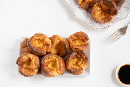 Yorkshire puddings in a white serving dish