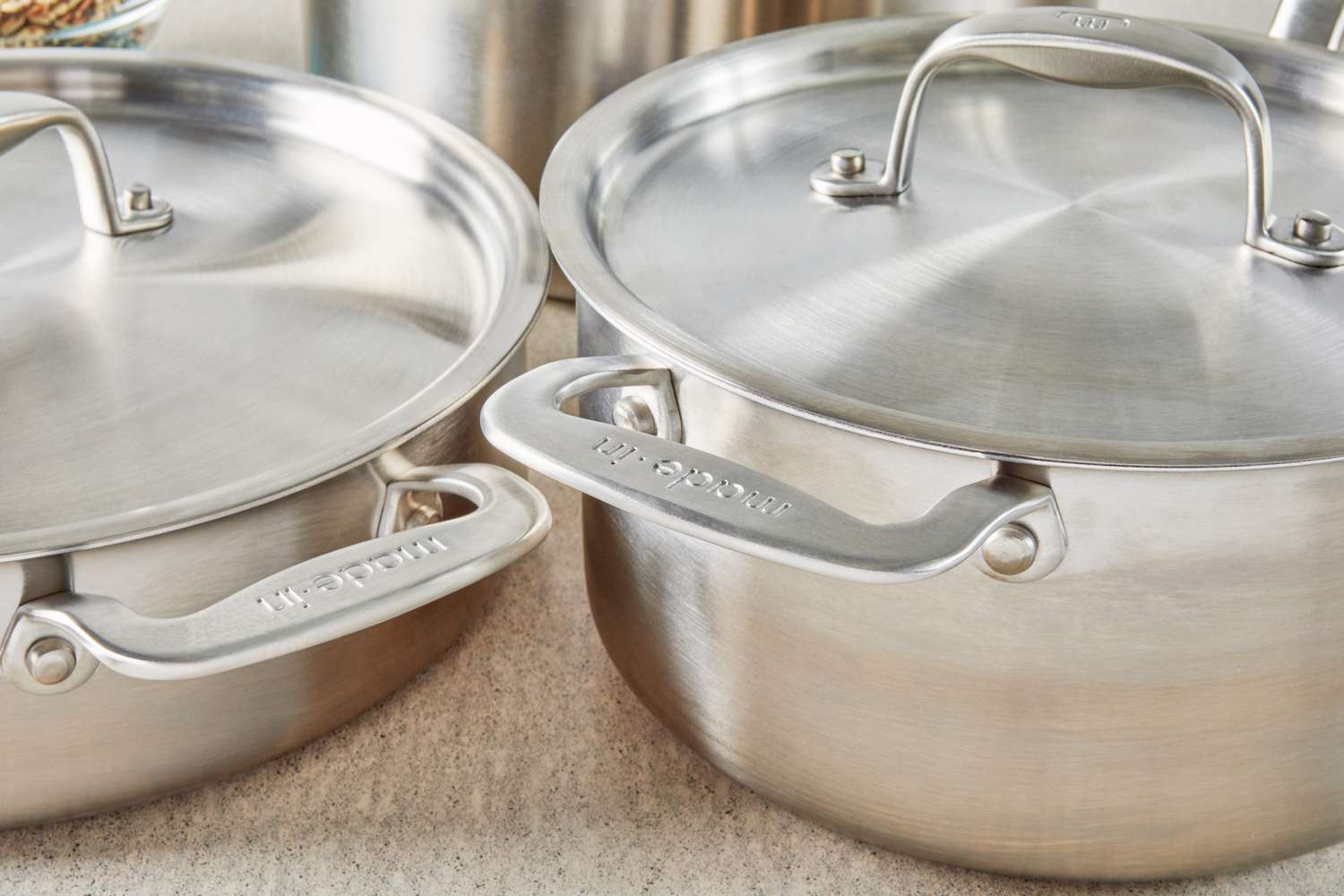 Closeup of Made In 7-Piece The Non Stick Set saute pan, stockpot, and lids displayed on countertop