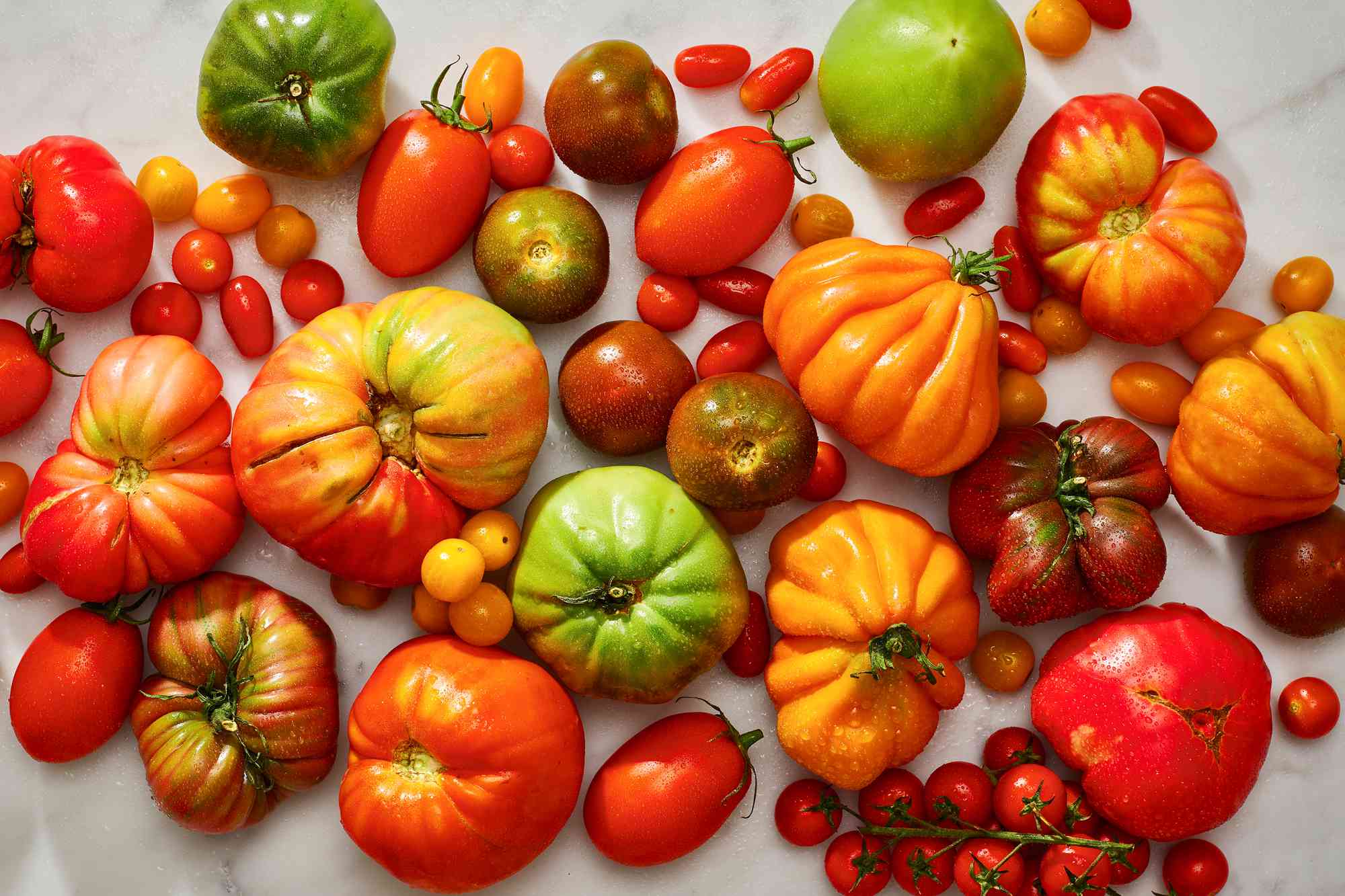 variety of tomatoes on marble surface 