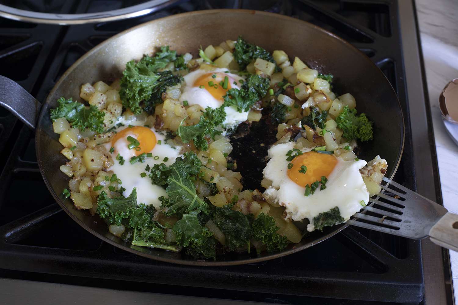 Matfer Bourgeat Black Carbon Steel Fry Pan with eggs on hash