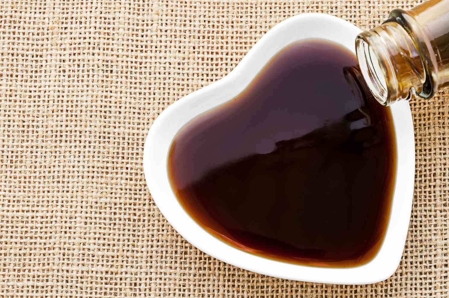 Oyster sauce being poured into a heart shaped bowl