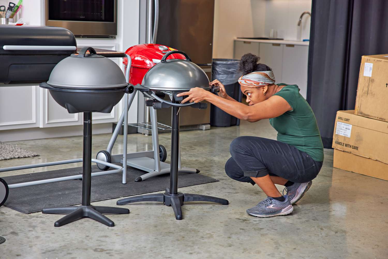 Person setting up grills indoors