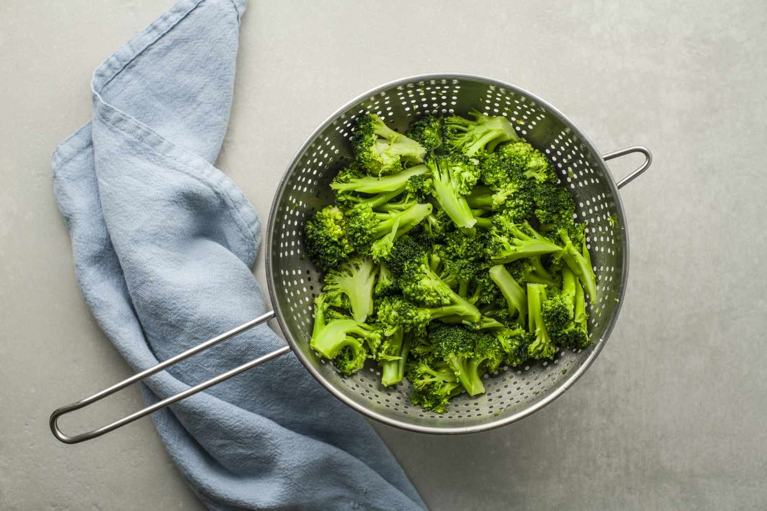 Cooked broccoli in a strainer