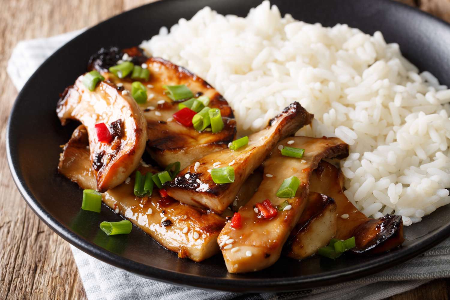 Fried spicy King Brown Mushroom with rice on a plate