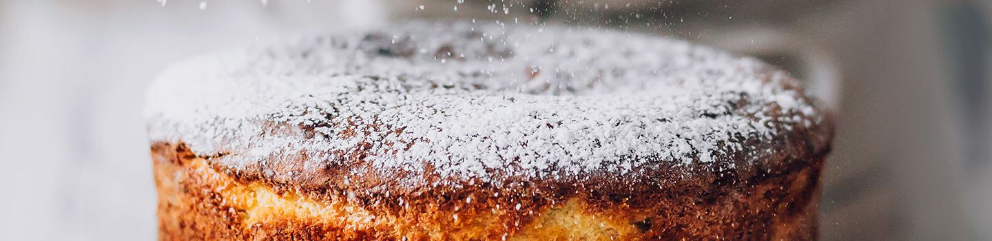 Powdered sugar sifted onto cake