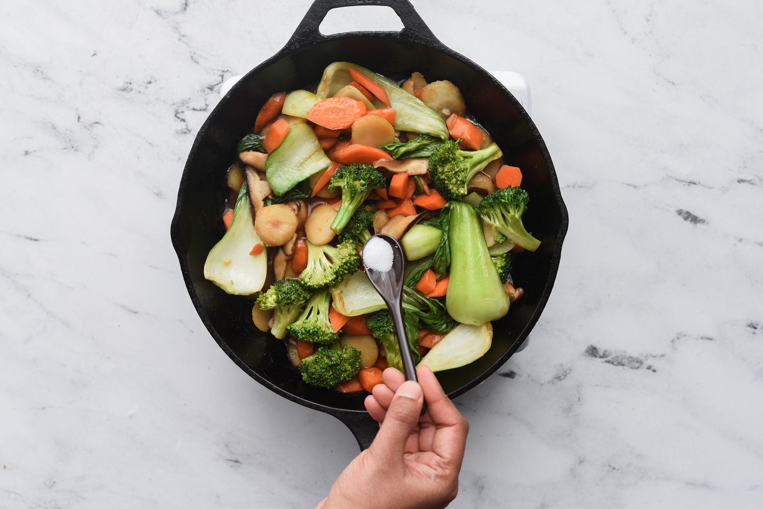 add salt to the stir-fry in the pan