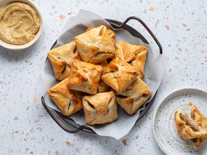 Jewish Meat Knishes in a bowl and on a plate, with mustard in a bowl 