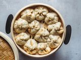 Steamed Chinese BBQ Pork Buns (Char Siu Bao) in a steamer basket 