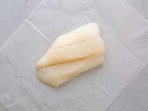 A cod fillet on parchment paper