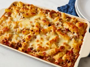 Cheesy baked ziti with beef in a white casserole dish