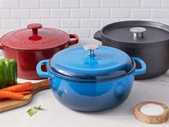 group photo of dutch ovens on a kitchen counter next to vegetables on a wooden cutting board 