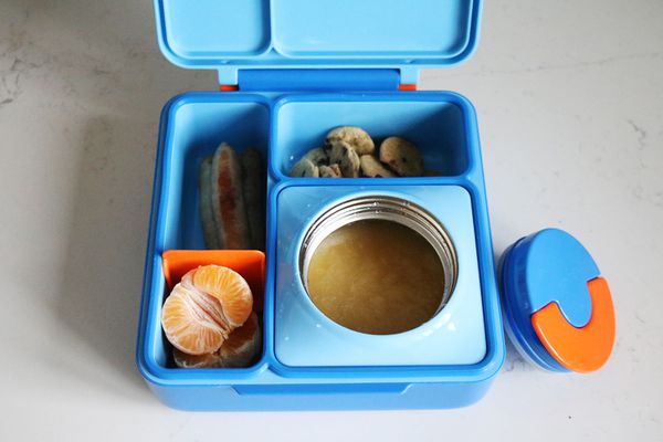 Omie Bento Box set on a marble surface full of food