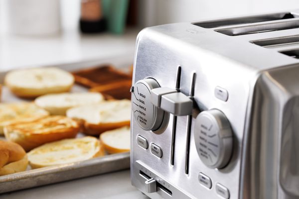 Closeup of the Cuisinart CPT-640 4-Slice Custom Select Toaster next to toasted bread on a baking sheet