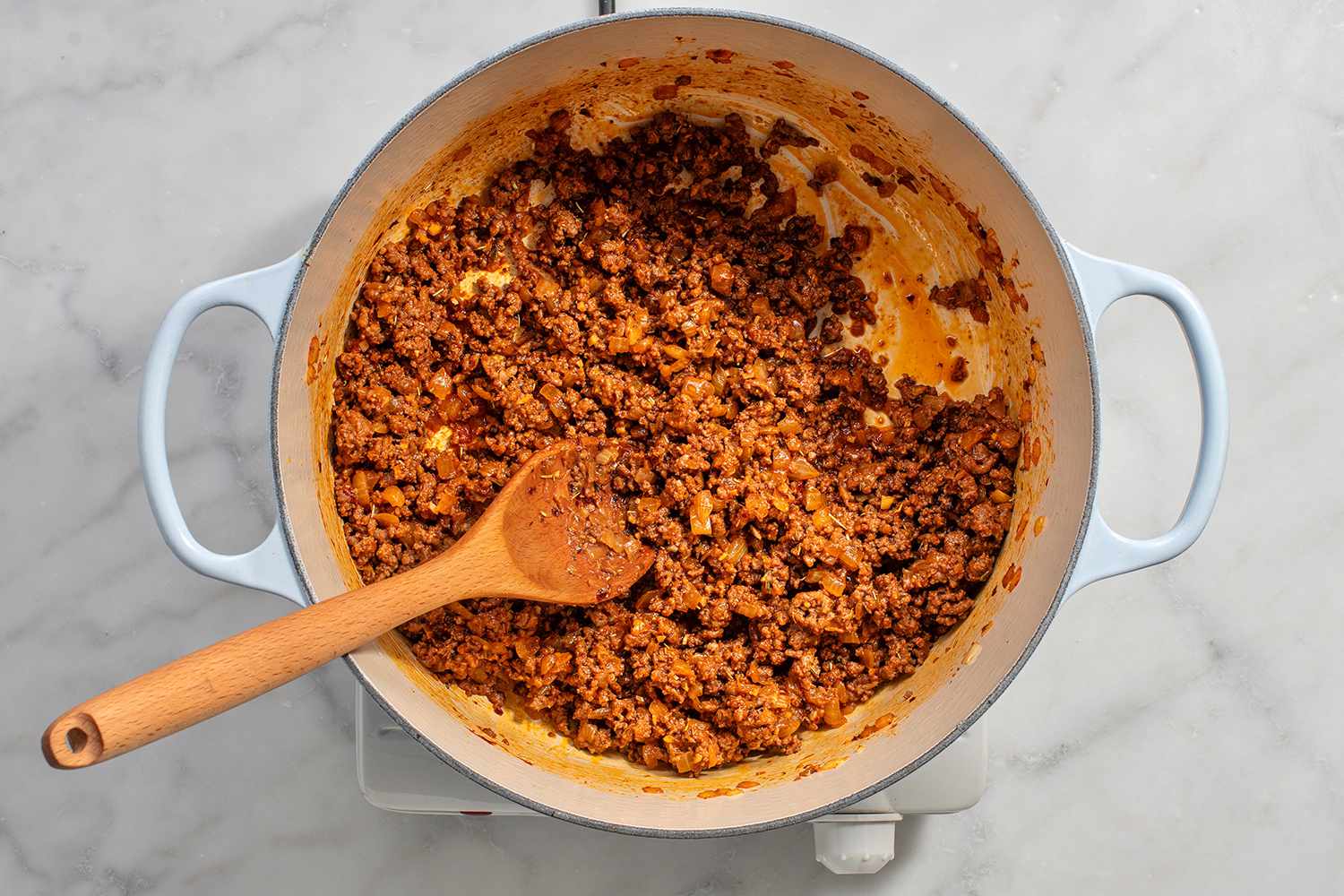 Ground beef and spices added to the dutch oven