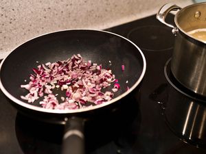 Red onions cooking in a non-stick pan