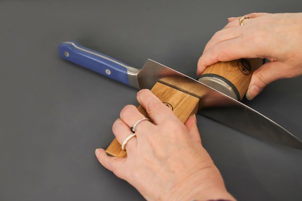 Someone sharping a knife with the HORL 2 Oak Rolling Knife Sharpener