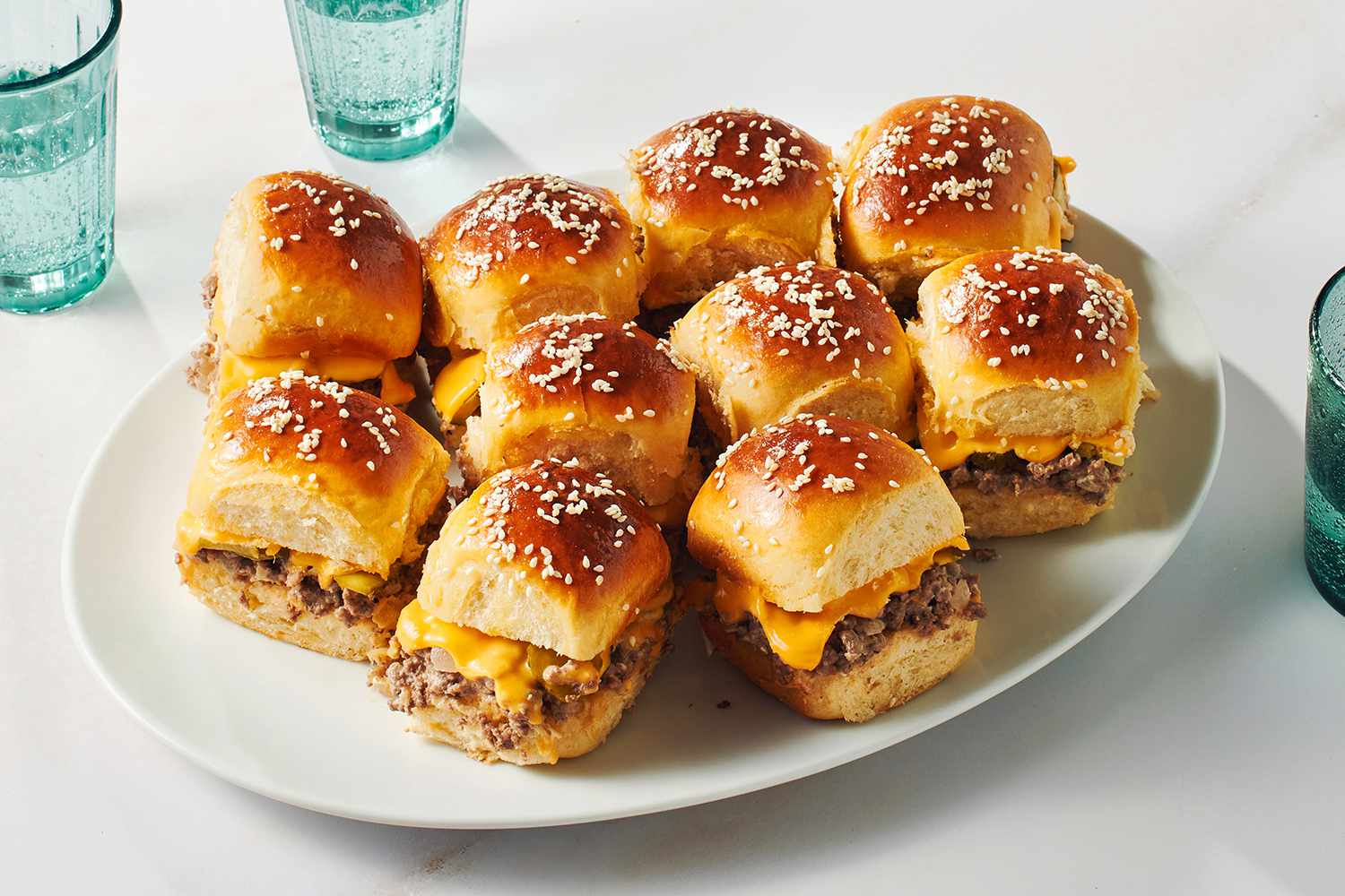 A serving plate of individual cheeseburger sliders