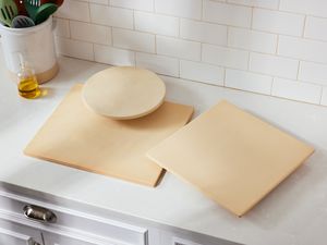 Best pizza stones displayed on a white kitchen countertop