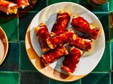 Filipino fried banana rolls on a plate