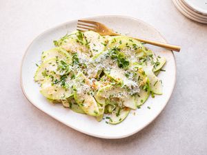 Sautéed chayote squash on a plate with a fork 