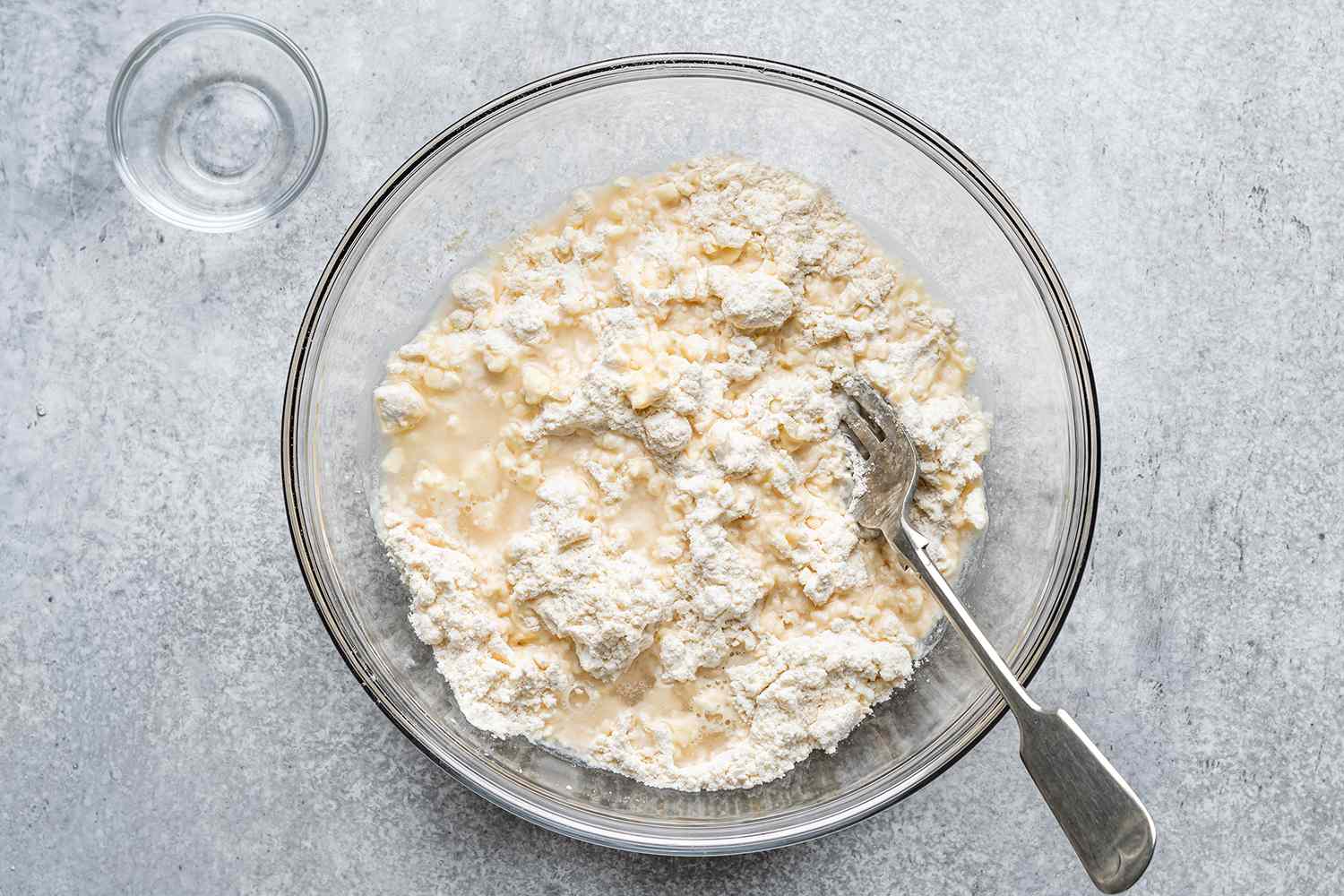 pastry dough mixed with vinegar in a glass bowl