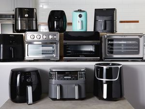 An assortment of air fryers displayed on a kitchen counter