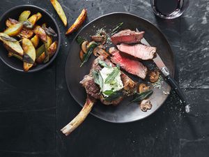 Tomahawk beef steak with mushrooms, burrata and sage potato wedges