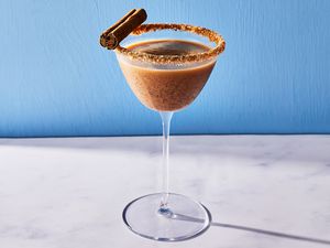 A pumpkin martini garnished with a cinnamon stick