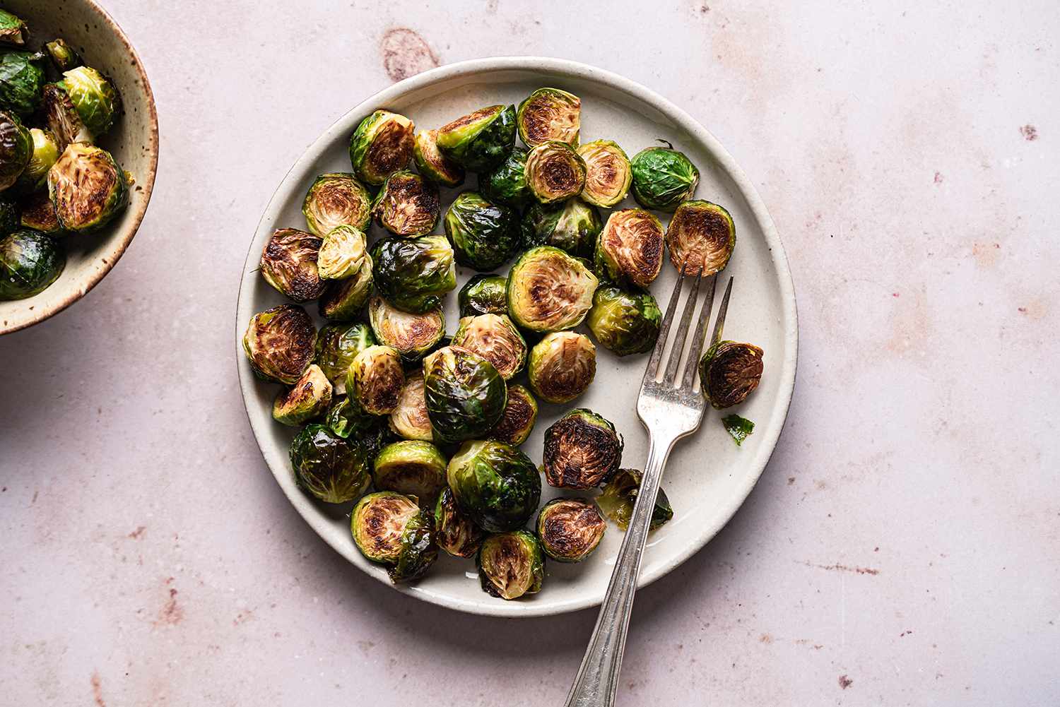 Roasted Brussels Sprouts on a plate with a fork 