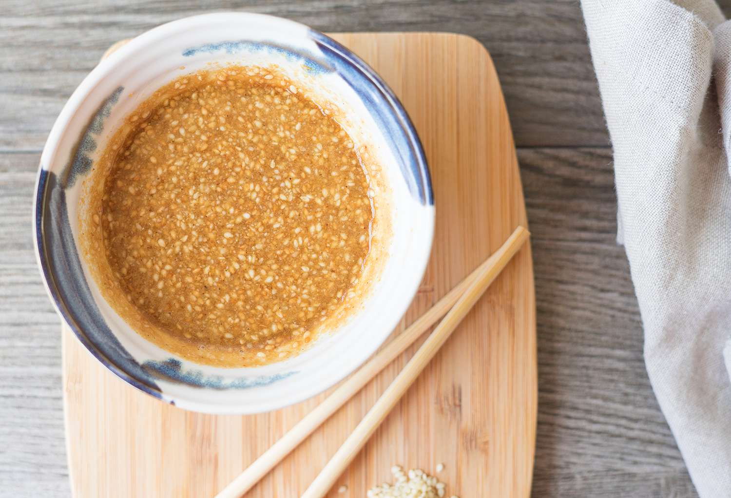 Japanese sesame salad dressing in a bowl with chopsticks nearby