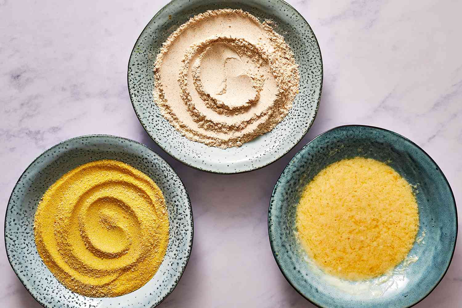 flour, cornmeal and beaten eggs on bowls