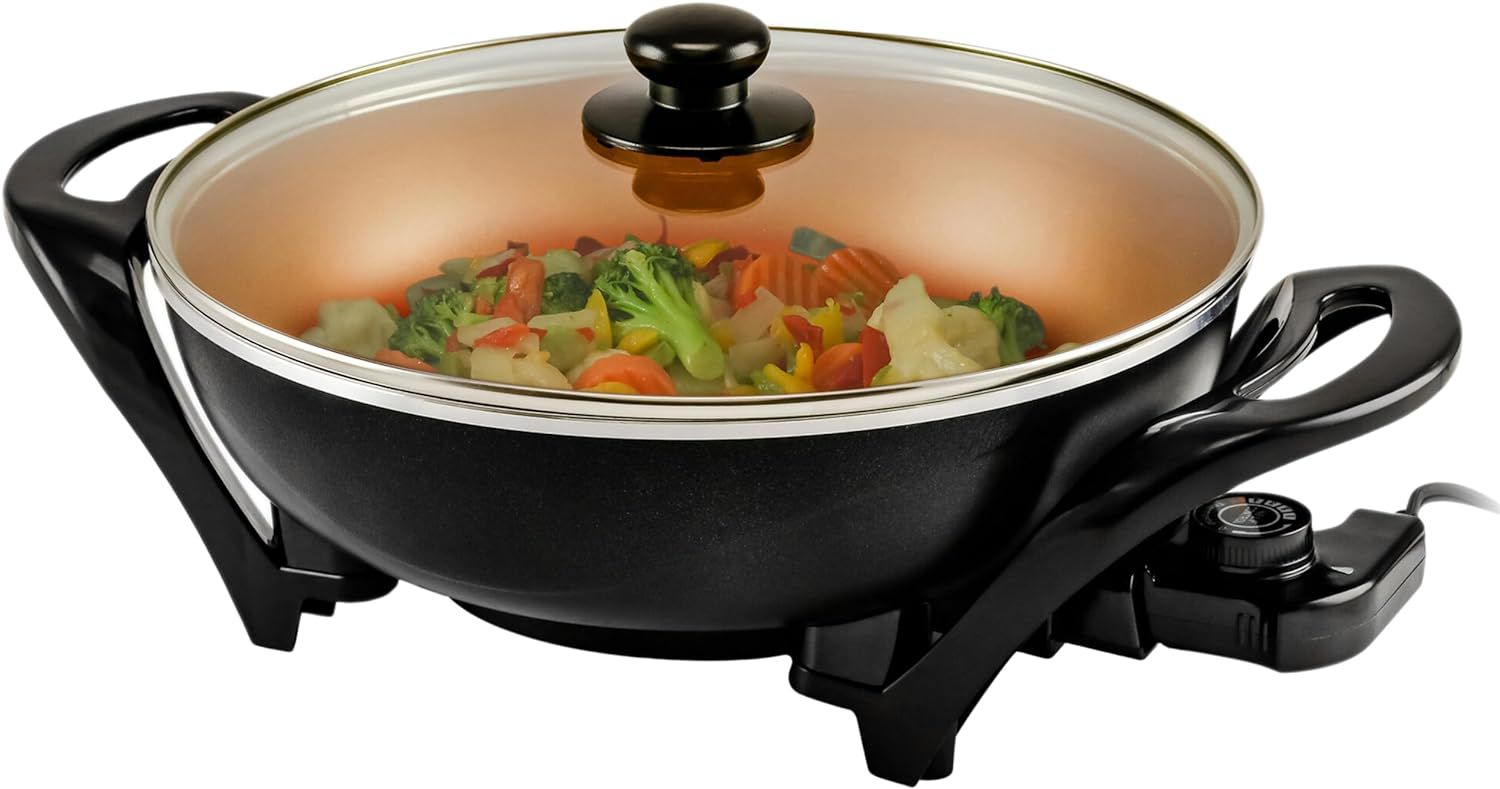 an Ovente electric wok with nonstick coating cooking steamed vegetables