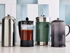 Side by side of French press coffee makers displayed on a white surface against a tiled background