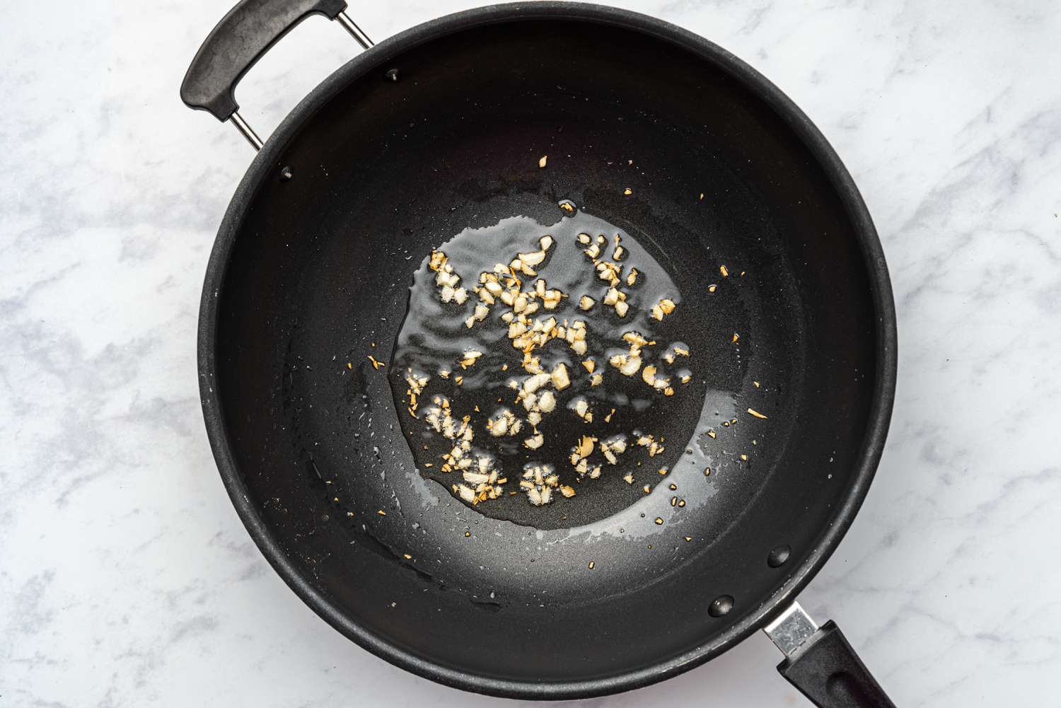 garlic frying in a wok