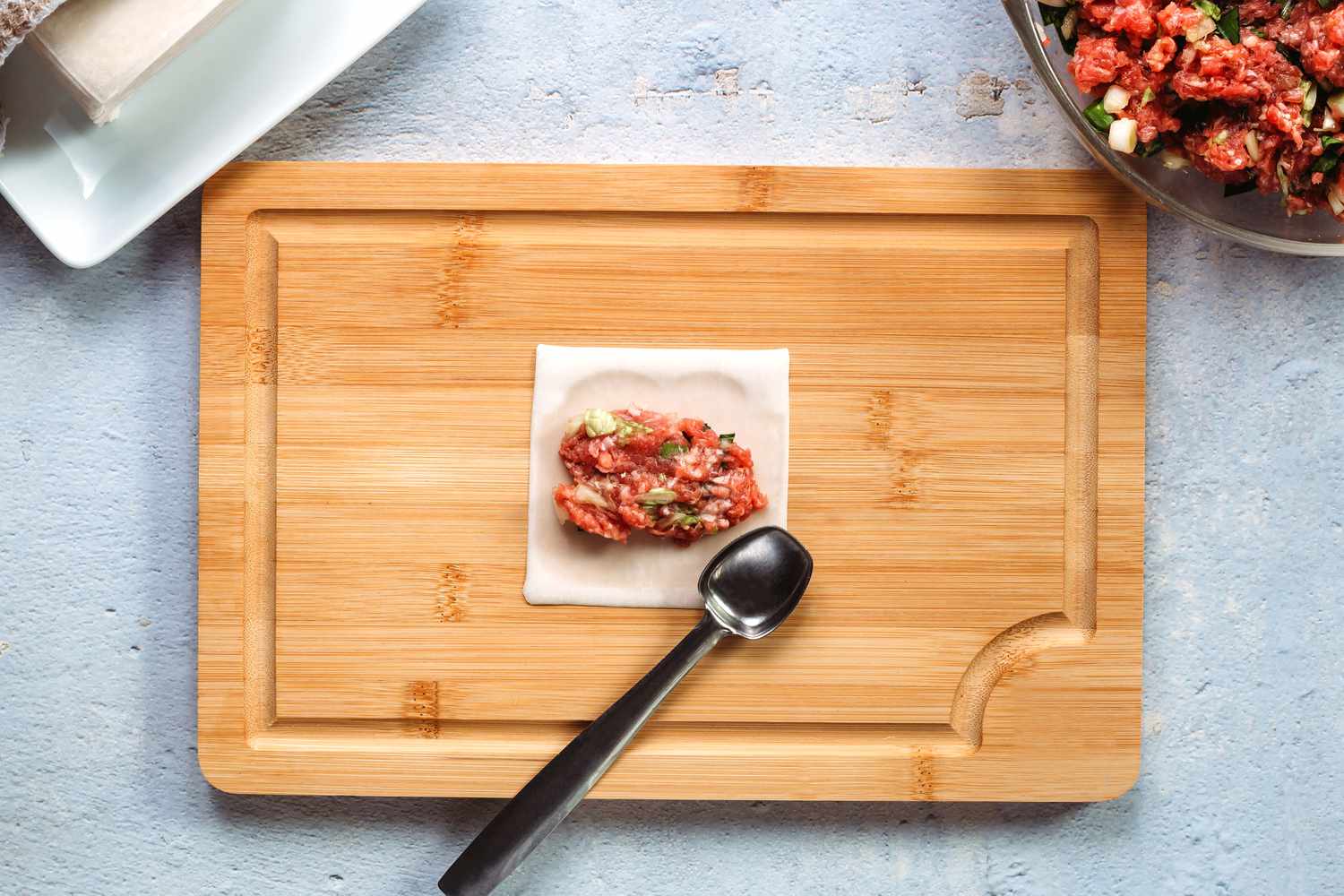 Wonton wrapper with filling on a cutting board