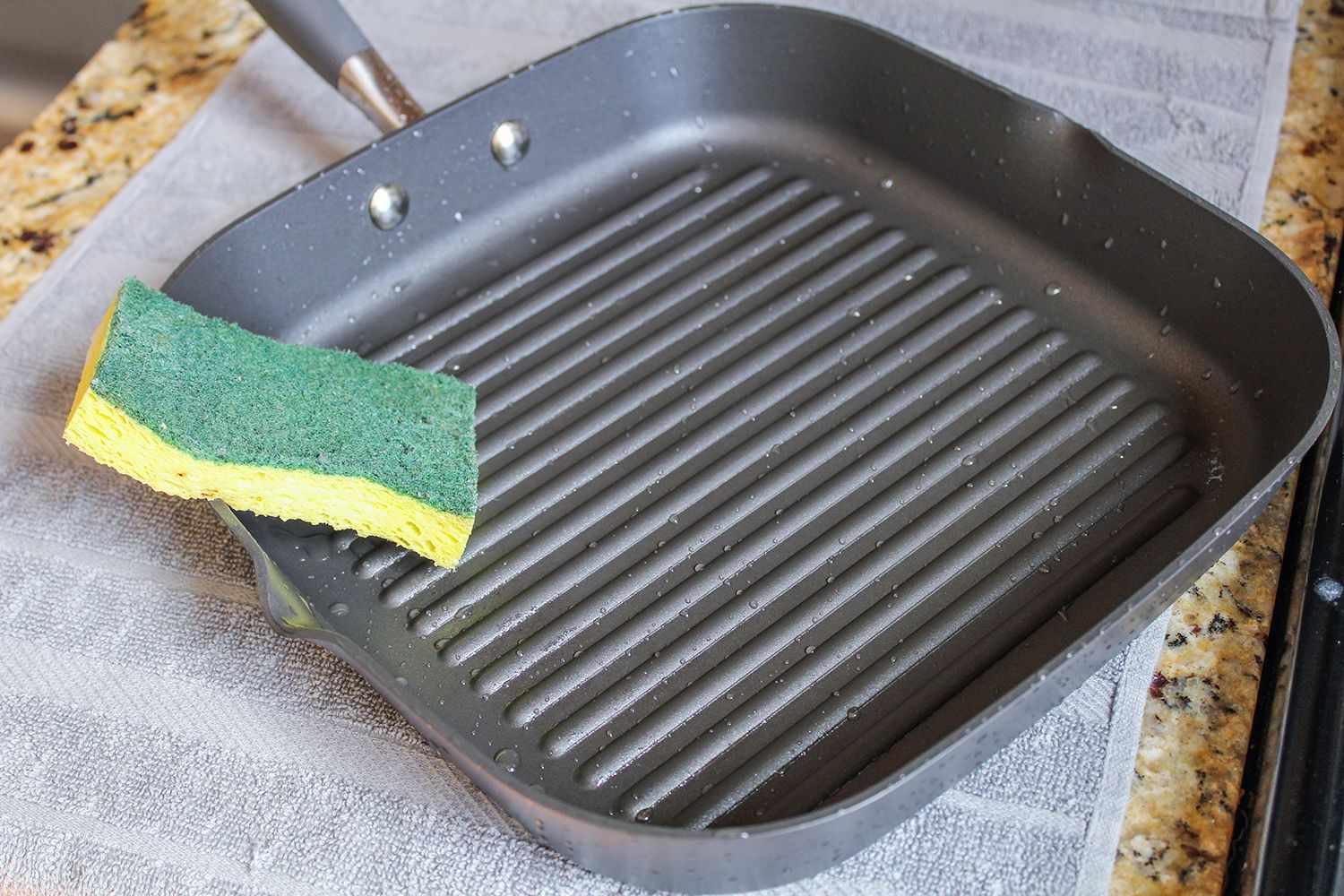Anolon Advanced Nonstick Square Grill Pan with a sponge inside