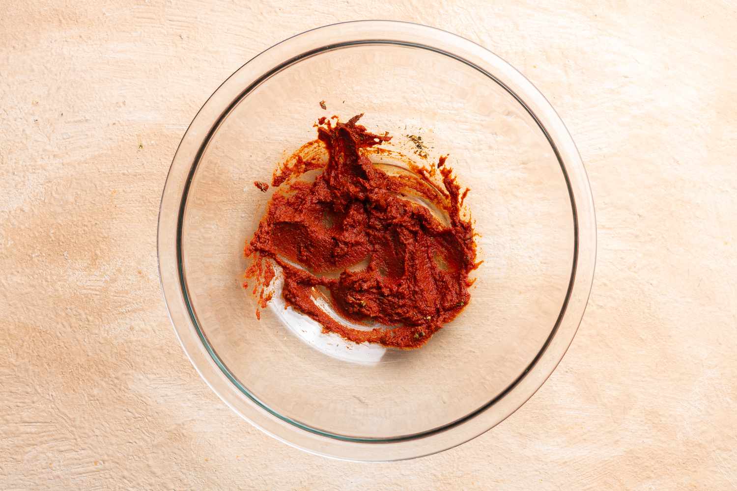 Place chipotle paste, ground cumin, oregano, cloves, and tomato paste in a large bowl