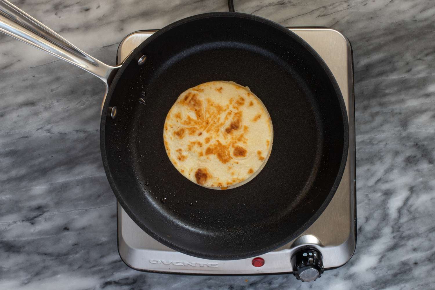 Quesadilla bun in a skillet.